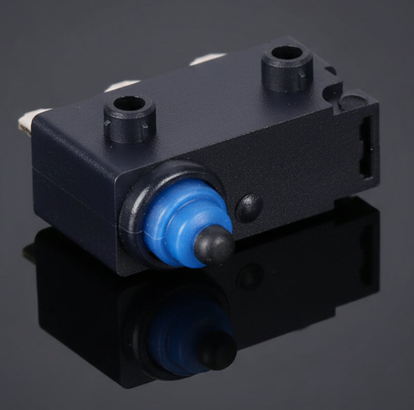Small mechanical switch with blue actuator on a white background